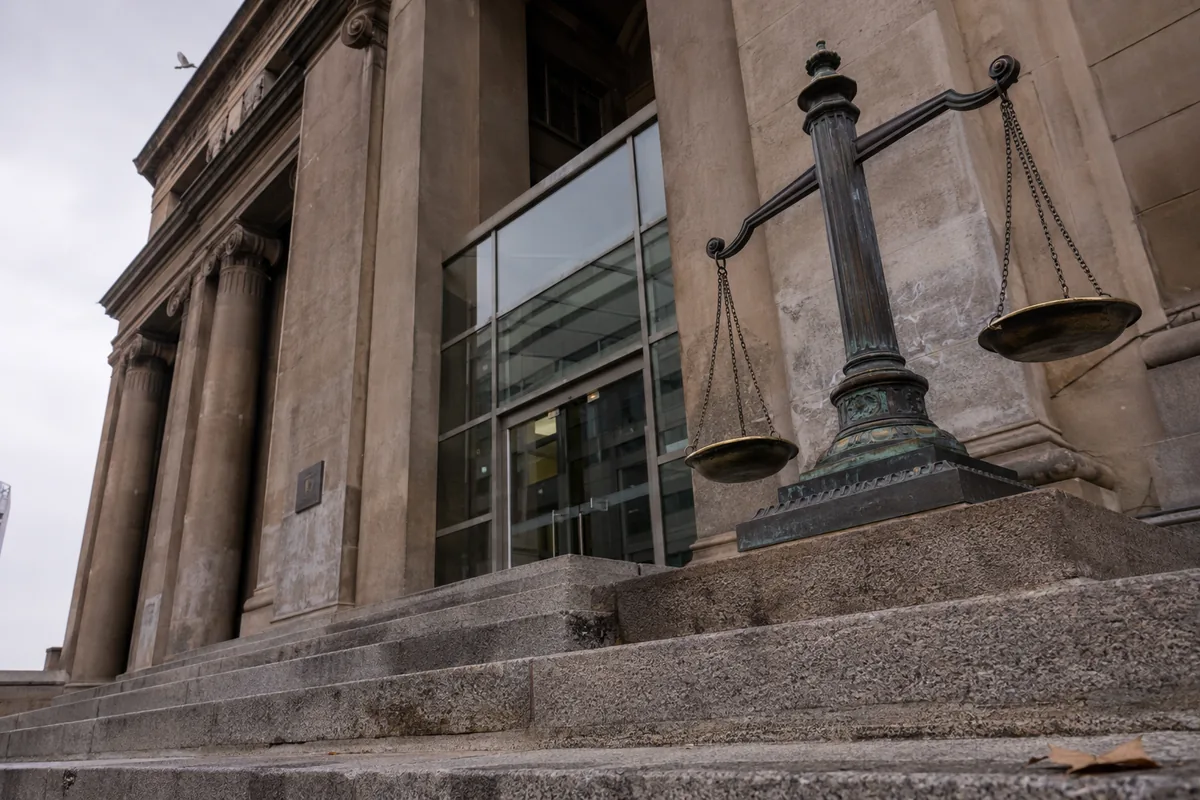 Escalinata de granito y balanza de bronce ante fachada institucional chilena con columnas neoclásicas: representación del marco legal aplicable y del procedimiento judicial penal por delitos del Art. 366 quáter